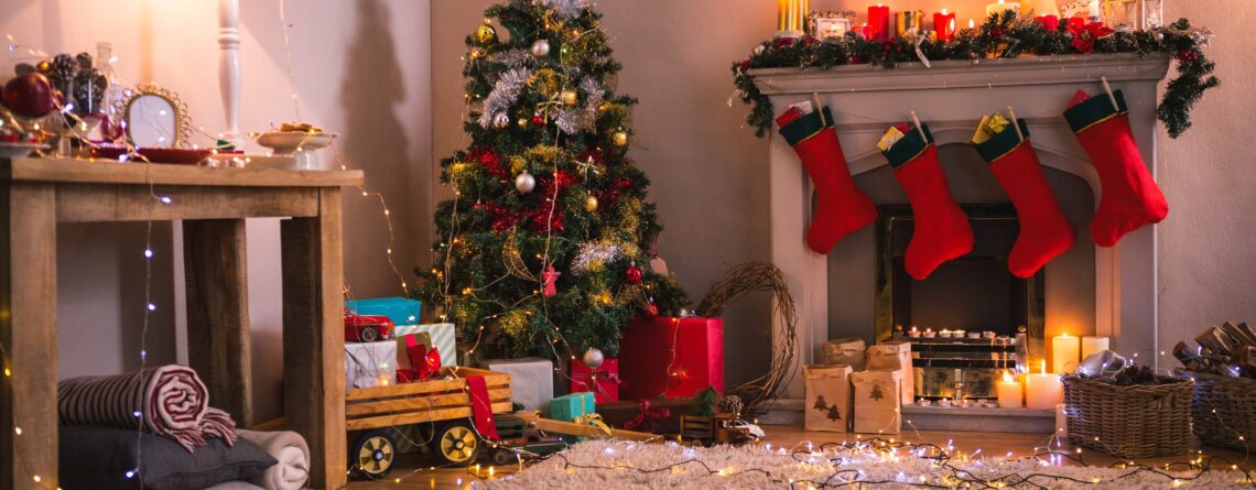 Christmas tree with presents near the fireplace