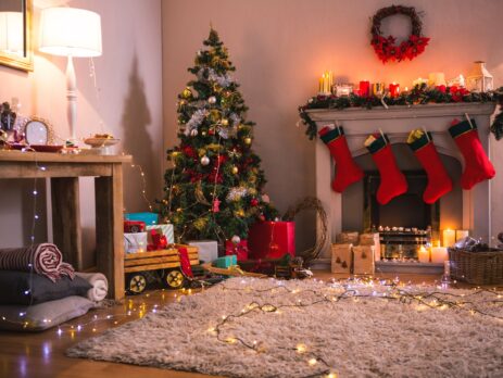 Christmas tree with presents near the fireplace